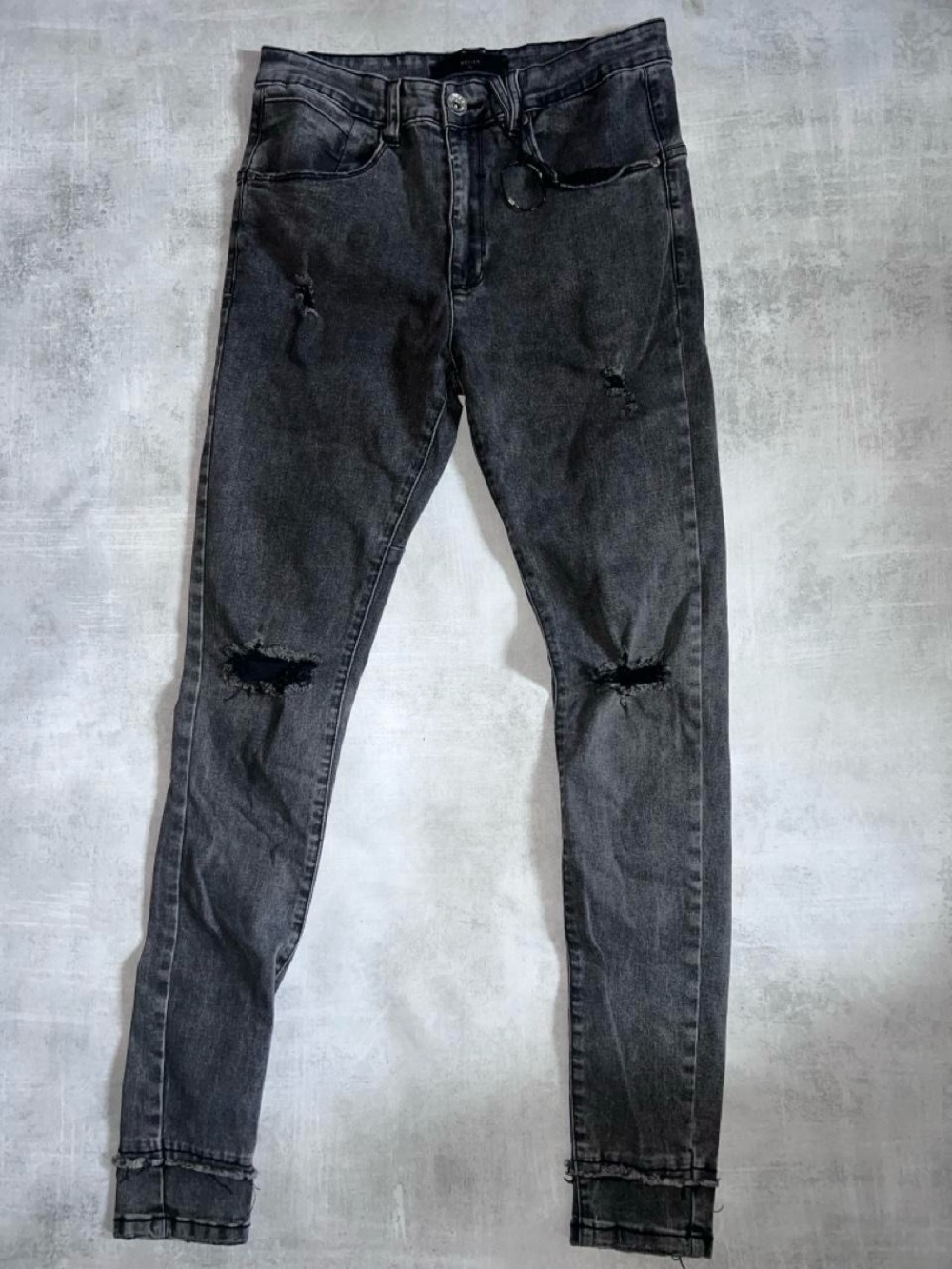 Kollar Denim a faded black or washed charcoal denim finish heavy distressing